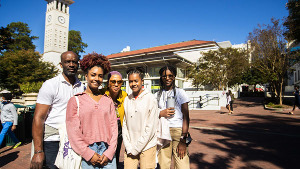 family posing in front of the Emory Student Center