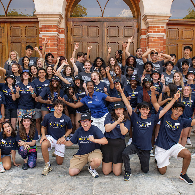 a crowd of students posing in a group and cheering